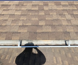 The same roof edge after new shingles and eave flashing were installed